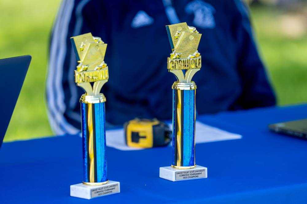 Blue trophies with Cornhole on top